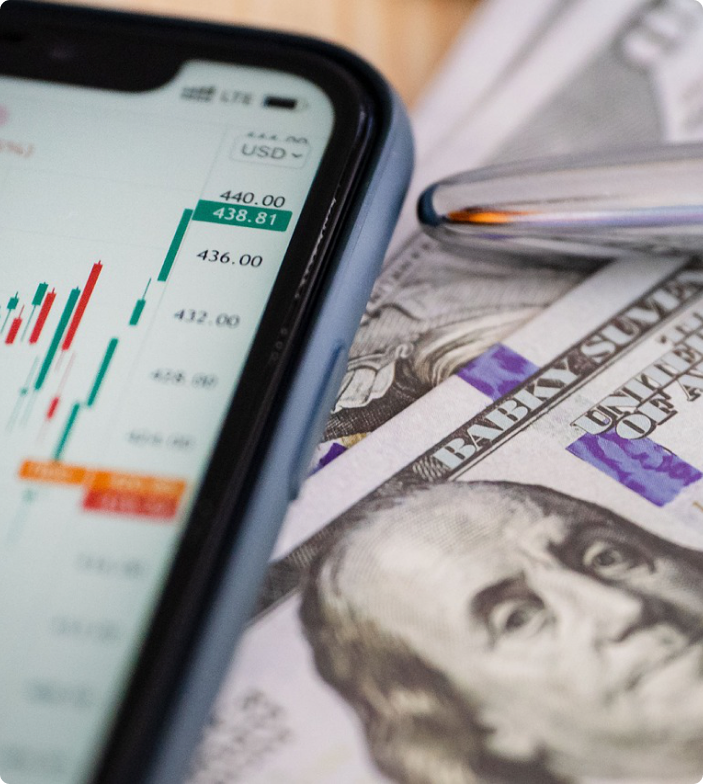 Mobile app showing financial charts and dollar bills representing digital finance platform